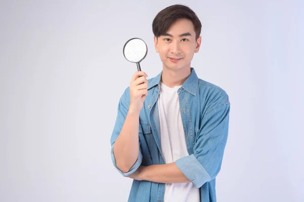 Young Asian Man Holding Magnifying Glass White Background Analysis Finance — стоковое фото