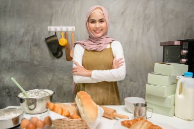 A Young beautiful muslim woman is baking in her kitchen , bakery and coffee shop business