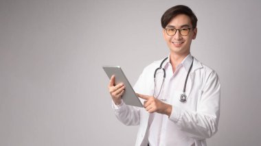 Portrait of male confident doctor over white background studio, healthcare and Medical technology concept.