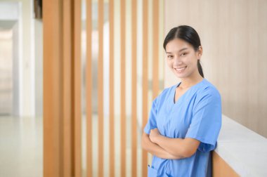 Portrait of Asian confident smiling female nurse working in hospital , health care concept 	