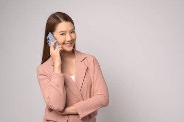 A Young asian woman using smartphone over white background, technology concept. 		