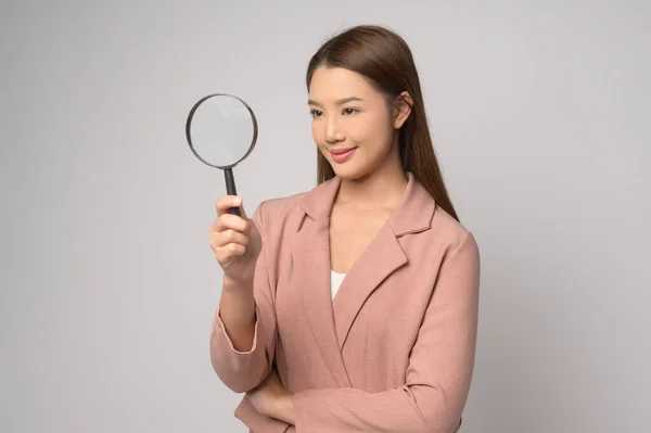Young Asian Woman Holding Magnifying Glass White Background Analysis Finance — стоковое фото