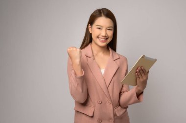 A Young asian woman using tablet over white background, technology concept. 	