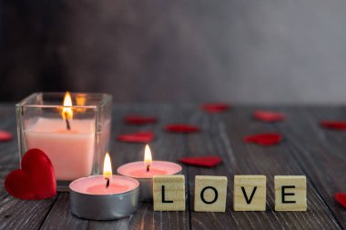 Love letters on the table. Heart, love, candle with flame. Postcard, wallpaper, banner, background. Valentine's Day.