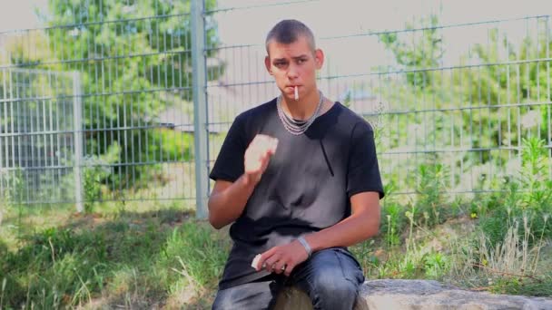 Young Guy Teenager Smokes Cigarettes Park Summer Leads Wrong Lifestyle — Stock video