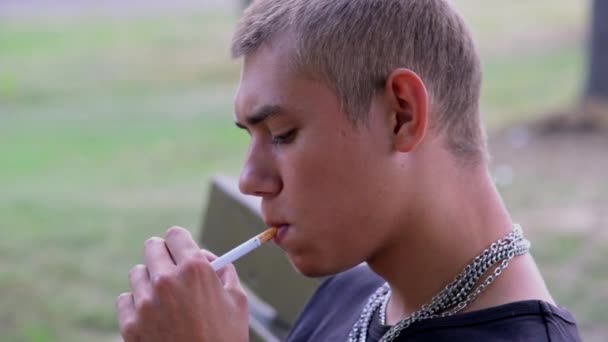 Young Guy Teenager Smokes Cigarettes Park Summer Leads Wrong Lifestyle — Stock video