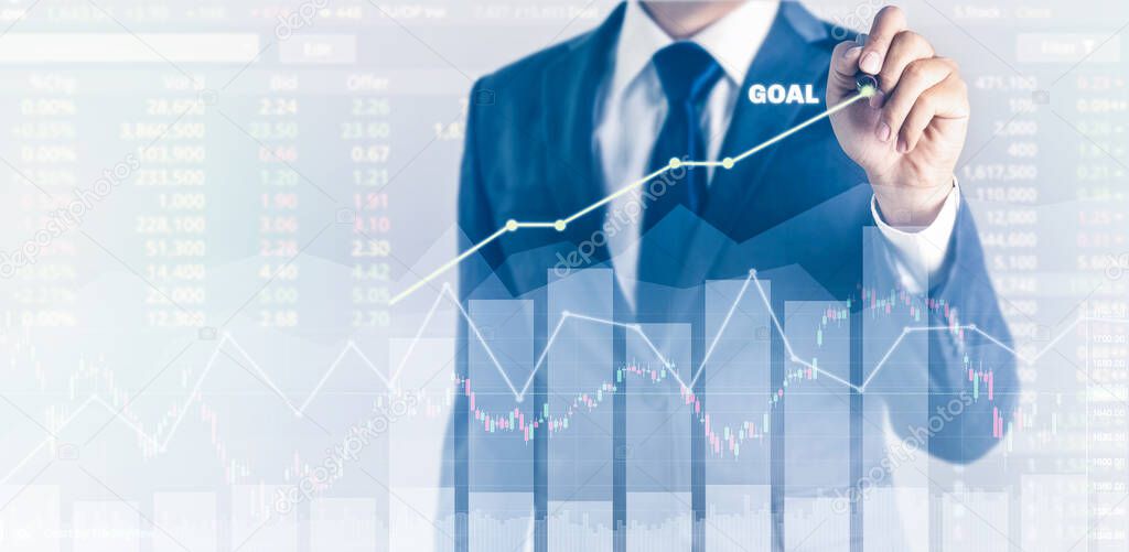 Growth success in goal concept. Businessman in blue suit plan with pen and increase of positive indicators in his business. graph business finance expectation plan year on number digit stock table.