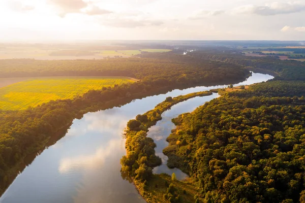 Yaz manzarası. Dönen bir nehir ağaçların ve tarlaların arasından akar.