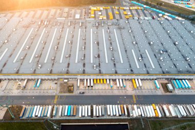 Warehouse and goods, top view of trucks waiting for loading near warehouse with goods from online store, logistics warehouse