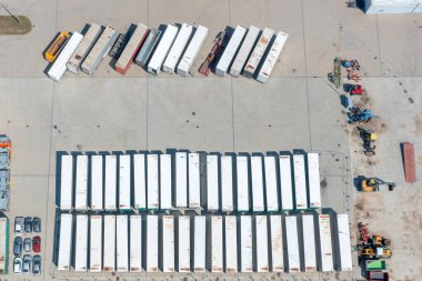 Colorful truck trailers parked next to each other seen from above