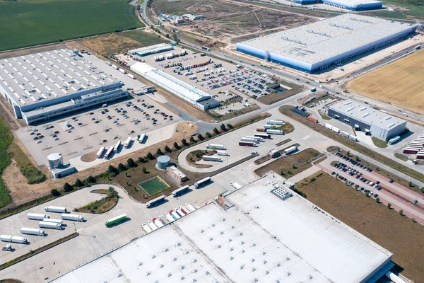 Aerial view of a warehouse of goods. Aerial view of loading and unloading trucks with goods in warehouse