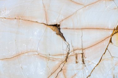 Texture of smooth cracked stone in orange color, sandstone close up for background