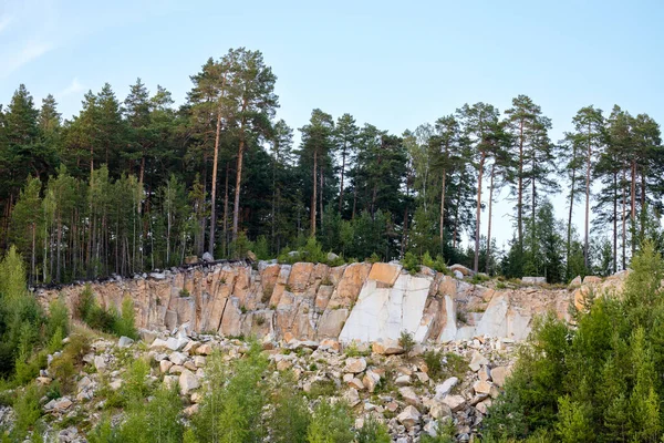 Rocky landscape in a sandy stone quarry, trees on the rocks