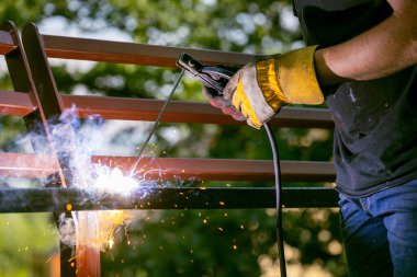 Welding metal by electric arc welding, close-up