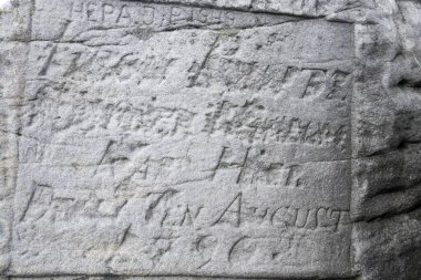 Old carved inscription on the rock, inscription on the rock