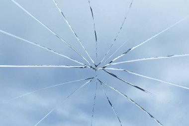 Crack on the glass against the sky, broken glass