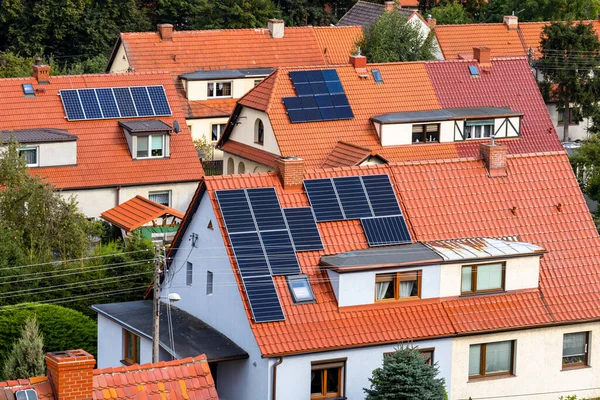 Solar panel on red tiled roof, alternative energy source for home
