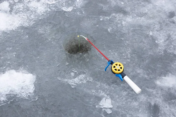 Ice fishing rod with the lure by the hole