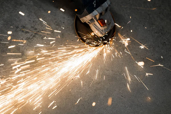 Metal processing with an angle grinder. sparks fly from hot metal
