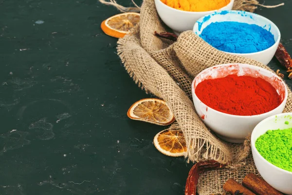 Traditional Indian Holi colours powder, spices on dark rustic background — Stock Photo, Image