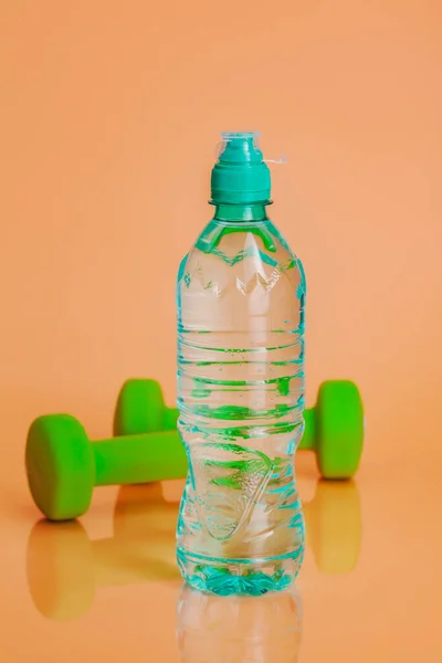 Plastic water bottles on a pastel beige background — Stock Photo, Image