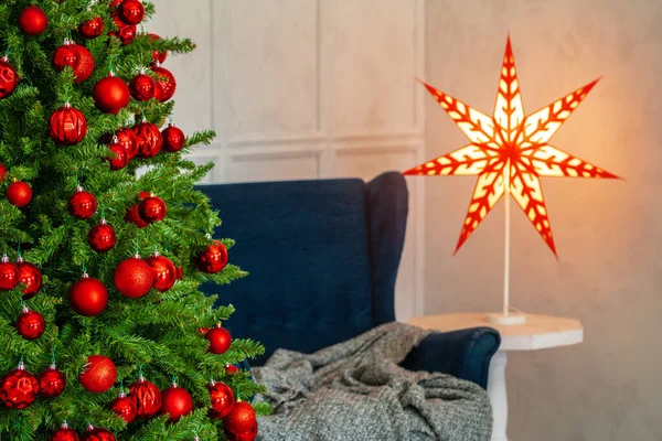 Διακοπές εσωτερικό. Όμορφο διακοσμημένο χριστουγεννιάτικο δέντρο με μπλε πολυθρόνα — Φωτογραφία Αρχείου