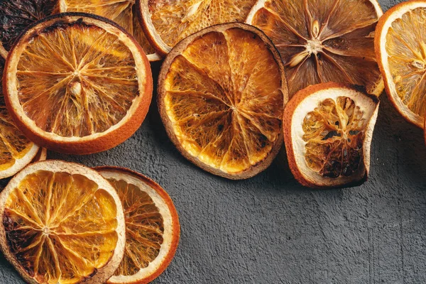 Dry orange slices on dark grey background — Stock Photo, Image