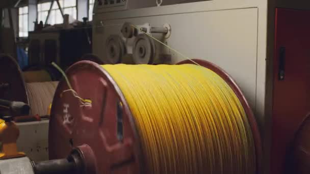 Spinnrolle mit gelbem Kabel in der Kabelproduktion in Großaufnahme — Stockvideo