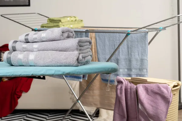 Housework concept. Ironing towels on ironing board — Stock Photo, Image