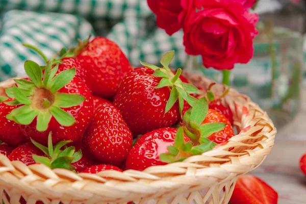 Basket of strawberry harvest on wooden table close up — Stock Photo, Image