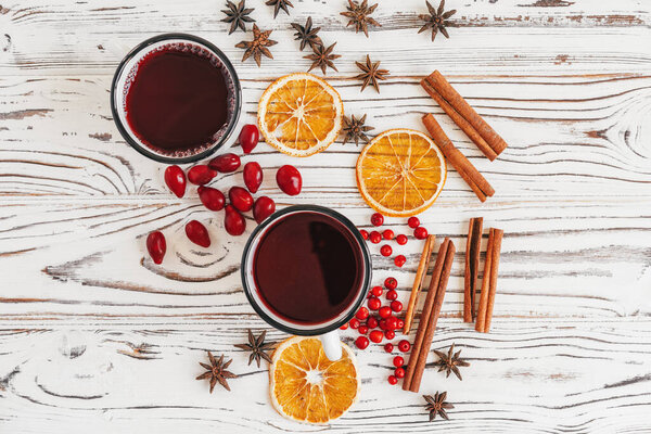 Autumn composition with hot mulled wine and spices on wooden background