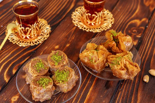 Turkish sweet baklava with Turkish tea on wooden background Stock Photo