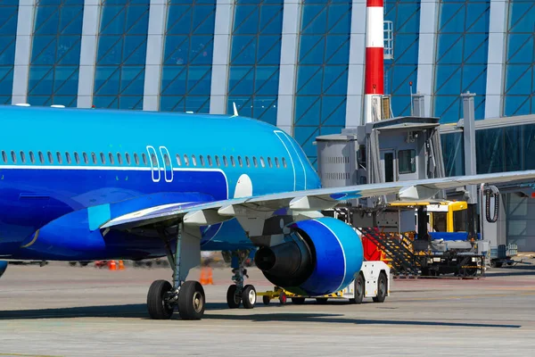 L'avion est stationné près de la porte d'embarquement de l'aéroport — Photo