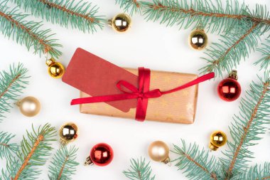 Noel hediyesi. Çam ağacı dalları ve küçük takılarla çevrili.