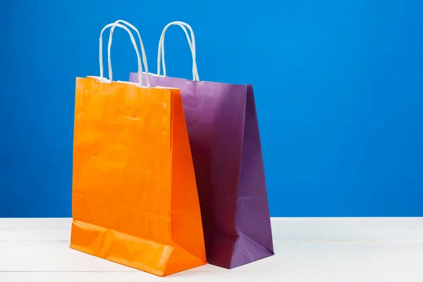 Bolsas de papel con espacio de copia sobre fondo azul —  Fotos de Stock