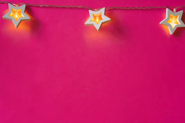 Guirnalda iluminada en forma de estrella sobre fondo de color de cerca — Foto de Stock