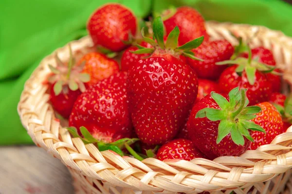 Basket of strawberry harvest on wooden table close up — Stock Photo, Image