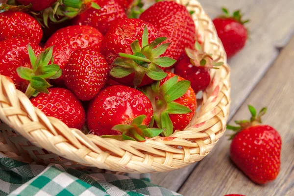 Basket of strawberry harvest on wooden table close up — Stock Photo, Image