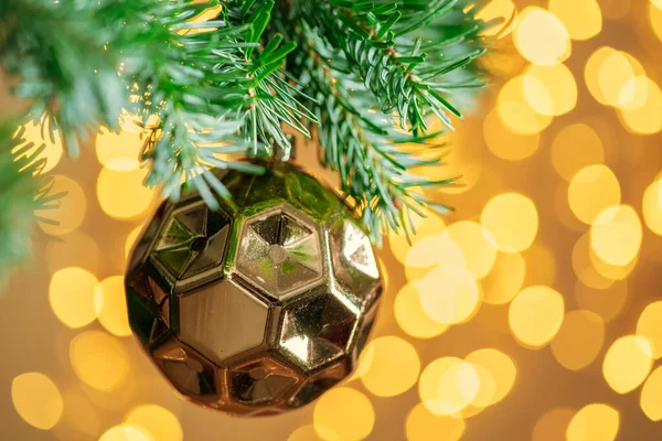Christmas tree background with golden bauble on bokeh sparkling — Stock Photo, Image