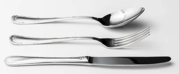 Spoon, fork and knife on a white background — Stock Photo, Image