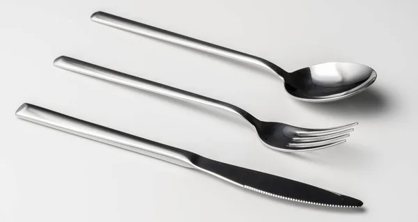 Spoon, fork and knife on a white background — Stock Photo, Image