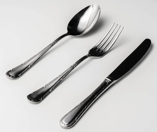 Spoon, fork and knife on a white background — Stock Photo, Image