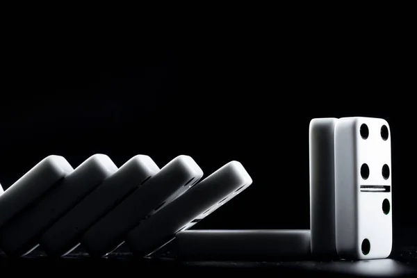 Domino pieces put in a row on black background — Stock Photo, Image
