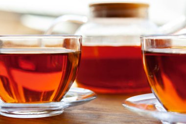 Sıcak bir fincan çay, ahşap kırsal masada.