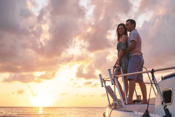 美しいカップルはヨットから夕日を見て — ストック写真
