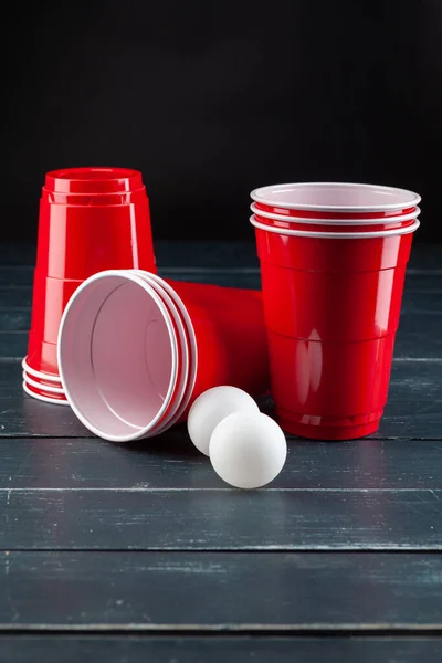 Mesa de madera con copas rojas y bola para pong de cerveza — Foto de Stock