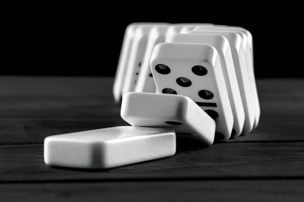 Domino game. Dominoes on a black table