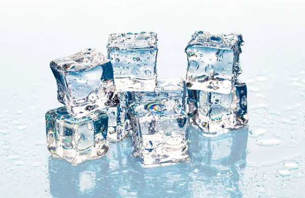 Quadratische schmelzende Eiswürfel auf nassem Tisch — Stockfoto