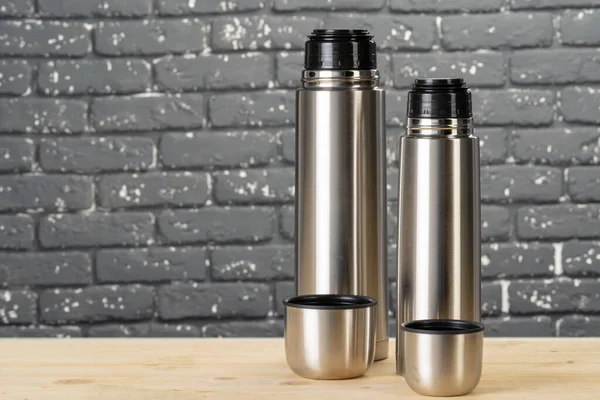 Aluminum metal thermos container bottle close up on table — Stock Photo, Image
