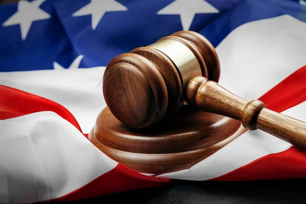 Gavel on wooden table with USA flag — Stock Photo, Image